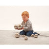 Un pequeño niño sentado en el suelo jugando con bolas de plata, una imagen de stock de Cornelia Parker, tendencia en Pinterest, arte cinético, trazado de rayos, fotografía de estudio, trazado de vray.