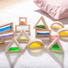Un grupo de juguetes de madera sentados en la parte superior de una cama, una escultura abstracta por Yuki Ogura, tendencia en Pinterest, arte ambiental, vidrieras, luz suave, luz de borde.