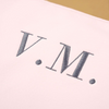 Carregar imagem no visualizador da galeria, Una toma cercana de una camiseta con la letra M, una pantalla de seda por Yoshiyuki Tomino, tumblr, accionismo vienés, logotipo, vray, foto.