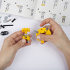 Load image into Gallery viewer, Una pareja de manos sosteniendo herramientas de construcción amarillas, un rompecabezas de Rube Goldberg, presentado en dribble, ensamblaje, behance hd, hecho de goma, atribución Creative Commons.