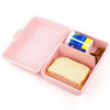 Laden Sie das Bild in den Galerie-Viewer, Una lonchera rosada con un sándwich y bocadillos dentro, una foto de stock de Yuki Ogura, Shutterstock, postminimalismo, foto de stock, foto de stock, estética Y2K.