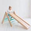 Un bebé está jugando en una diapositiva de madera, una escultura abstracta por Ottilie Maclaren Wallace, que está de moda en Pinterest, arte cinético, composición dinámica, ortogonal, caprichoso.