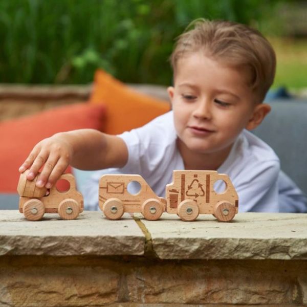 Un joven niño jugando con un camión de juguete de madera, una renderización 3D de Keos Masons, destacada en CG Society, movimiento de artes y oficios, profundidad de campo, hecho de cartón, angular.