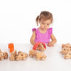 Una pequeña niña jugando con juguetes de madera en una mesa, una foto de stock por Keos Masons, presentada en Shutterstock, constructivismo modular, foto de stock, foto de stock, composición dinámica.