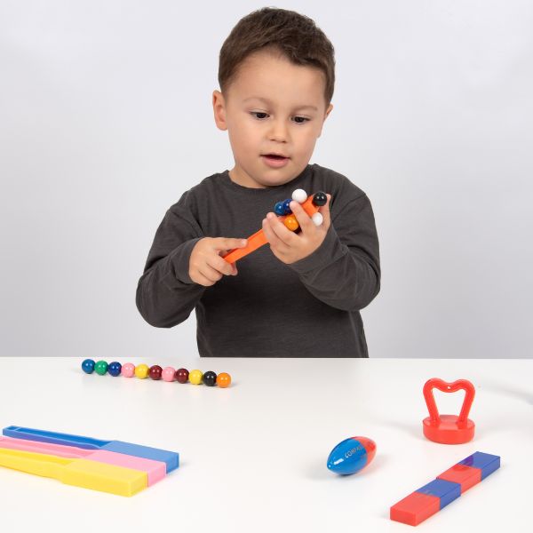 Un joven niño está jugando con juguetes en una mesa, una foto de stock por Ernő Rubik, destacada en cg society, de stijl, ortogonal, foto de stock, foto de stock.