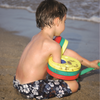 Un joven sentado en la playa con un frisbee, un rompecabezas de Zvest Apollonio, ganador del concurso de Shutterstock, plasticien, atribución de Creative Commons, ortogonal, fotografía de stock.